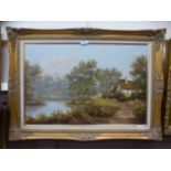 A gilt framed oil on canvas of cottage by lake scene,