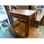 A nest of three mid-20th century teak occasional tables