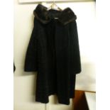 A black sheepskin coat with fur collar by Astra Furs