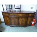 A reproduction mahogany breakfront sideboard having a centre drawer above pair of doors flanked by