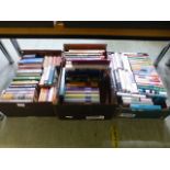 Three trays of hardback books on various subjects