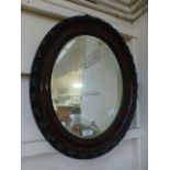 An early 20th century oval bevel glass mirror