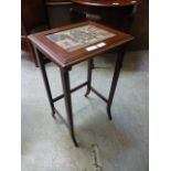 An early 20th century mahogany occasional table with continental town scene print under glass to