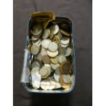 A tin containing a quantity of coinage