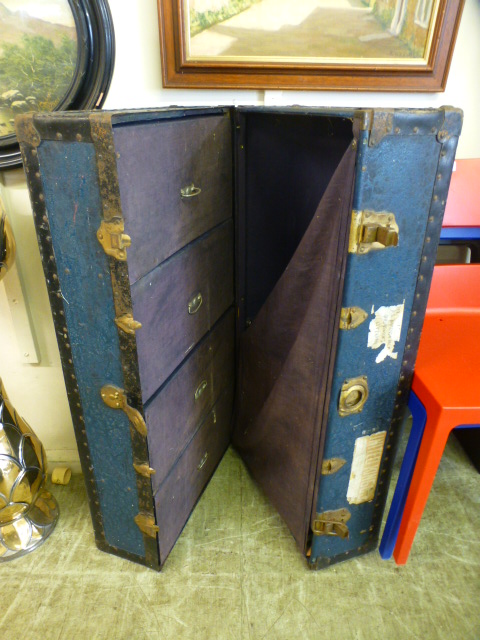 An early 20th century blue metal bound travelling case with fitted interior