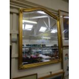 A reproduction gilt framed bevelled glass wall mirror