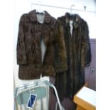 A brown fur jacket along a brown fur coat