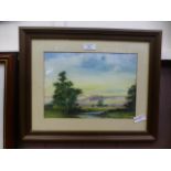 A framed and glazed watercolour of a country lake scene