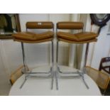 A pair of tan leather seated,