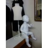 A seated child's mannequin along with a child's tailors dummy