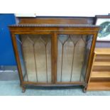 An early 20th century walnut bow fronted glazed display cabinet CONDITION REPORT: