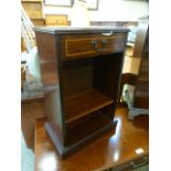 A reproduction mahogany cabinet having single drawer above open storage
