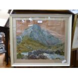 A framed and glazed needlework of mountain scene having a bridge over a river