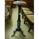 A Victorian black painted jardiniere stand