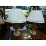 A pair of plaster cream table lamps with shades