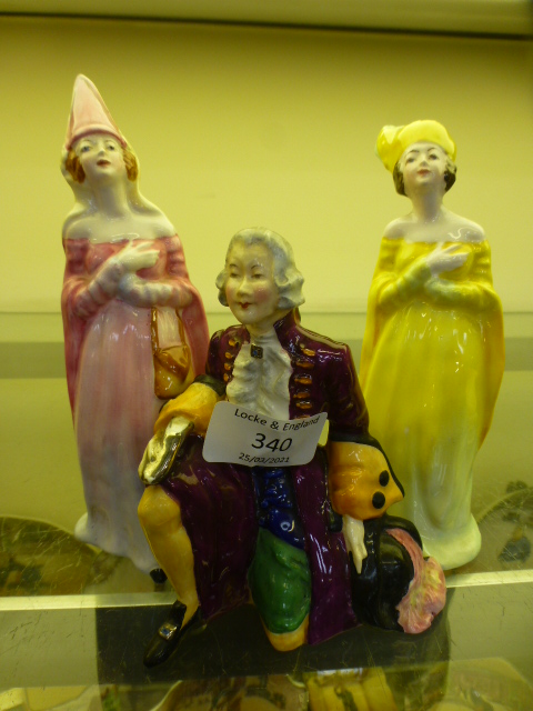 A Crown Staffordshire figure of a gentleman together with two ladies