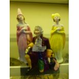 A Crown Staffordshire figure of a gentleman together with two ladies