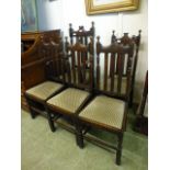 A set of five early 20th century oak framed dining chairs, one carver,