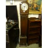 An early 20th century oak cased granddaughter clock having Westminster chimes