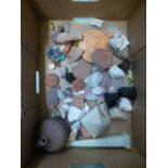 A box containing an assortment of pottery fragments, trinkets etc.