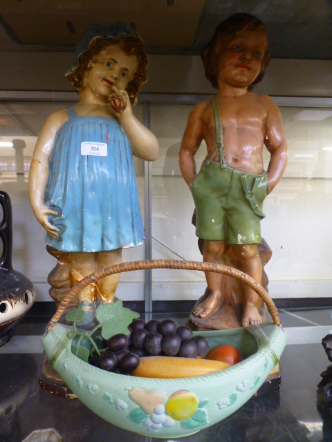Two early 20th century plaster models of children together with a ceramic fruit basket with faux