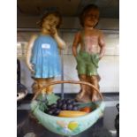 Two early 20th century plaster models of children together with a ceramic fruit basket with faux