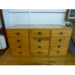 A modern bank of twelve pine drawers