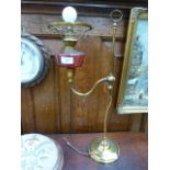 A converted brass and cranberry glass table lamp