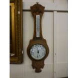 An early 20th century carved oak banjo barometer