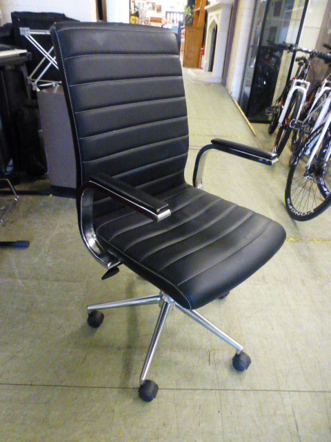 A black leather effect office chair on five star base