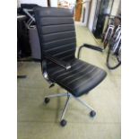 A black leather effect office chair on five star base