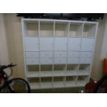 A white laminate storage unit comprising of pigeon holes, drawers and cupboards h. 182 cm, w.