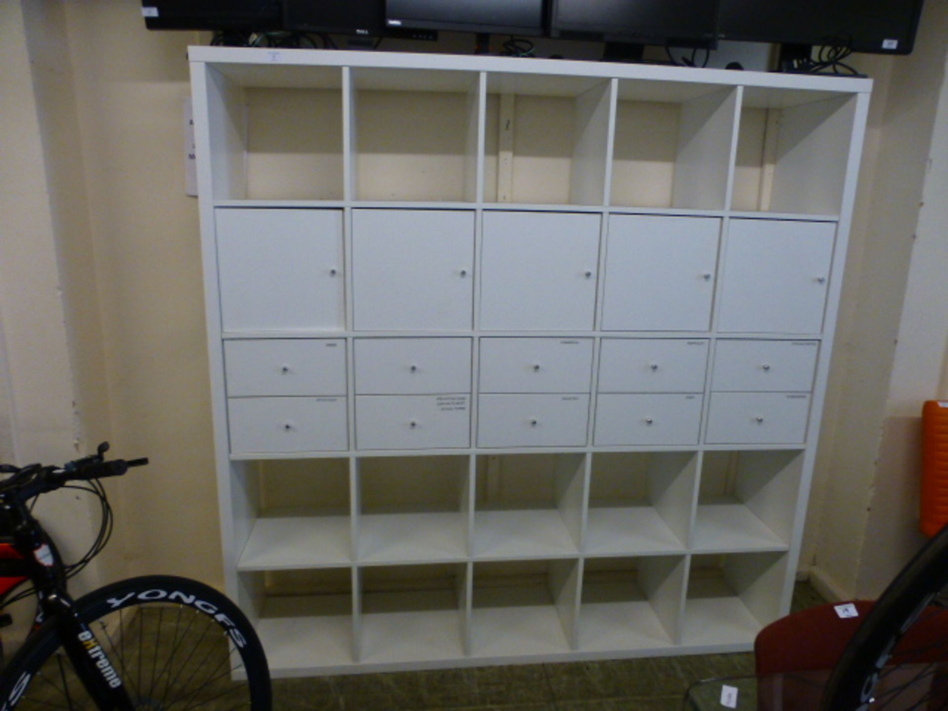 A white laminate storage unit comprising of pigeon holes, drawers and cupboards h. 182 cm, w.