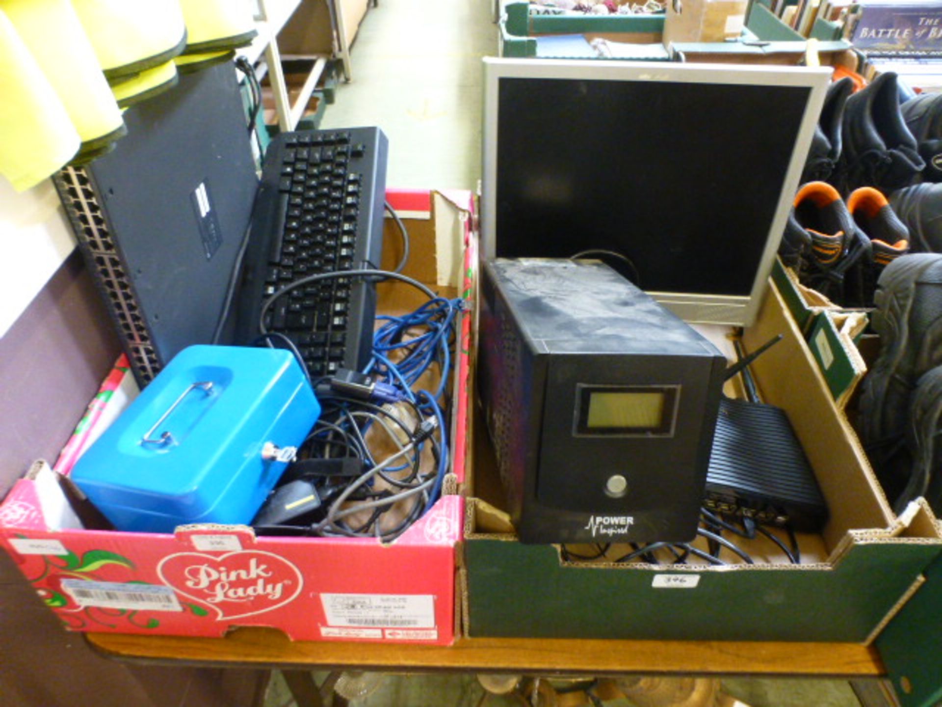 Two trays containing computer equipment to include monitor, keyboard, power pack, cash tin etc.