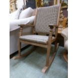 A teak and wicker rocking chair