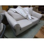 A modern two seater settee upholstered in a biscuit coloured fabric
