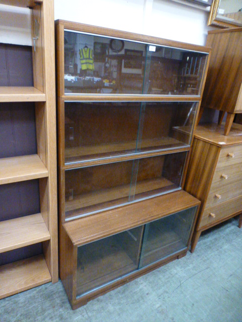 A 1960s sliding glass door four tier bookcase by Minty