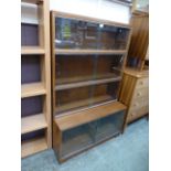 A 1960s sliding glass door four tier bookcase by Minty