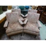 A set of four early 20th century walnut framed open armchairs upholstered in a pink floral cut