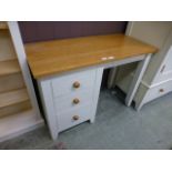 A modern pine dressing table having a bank of three drawers