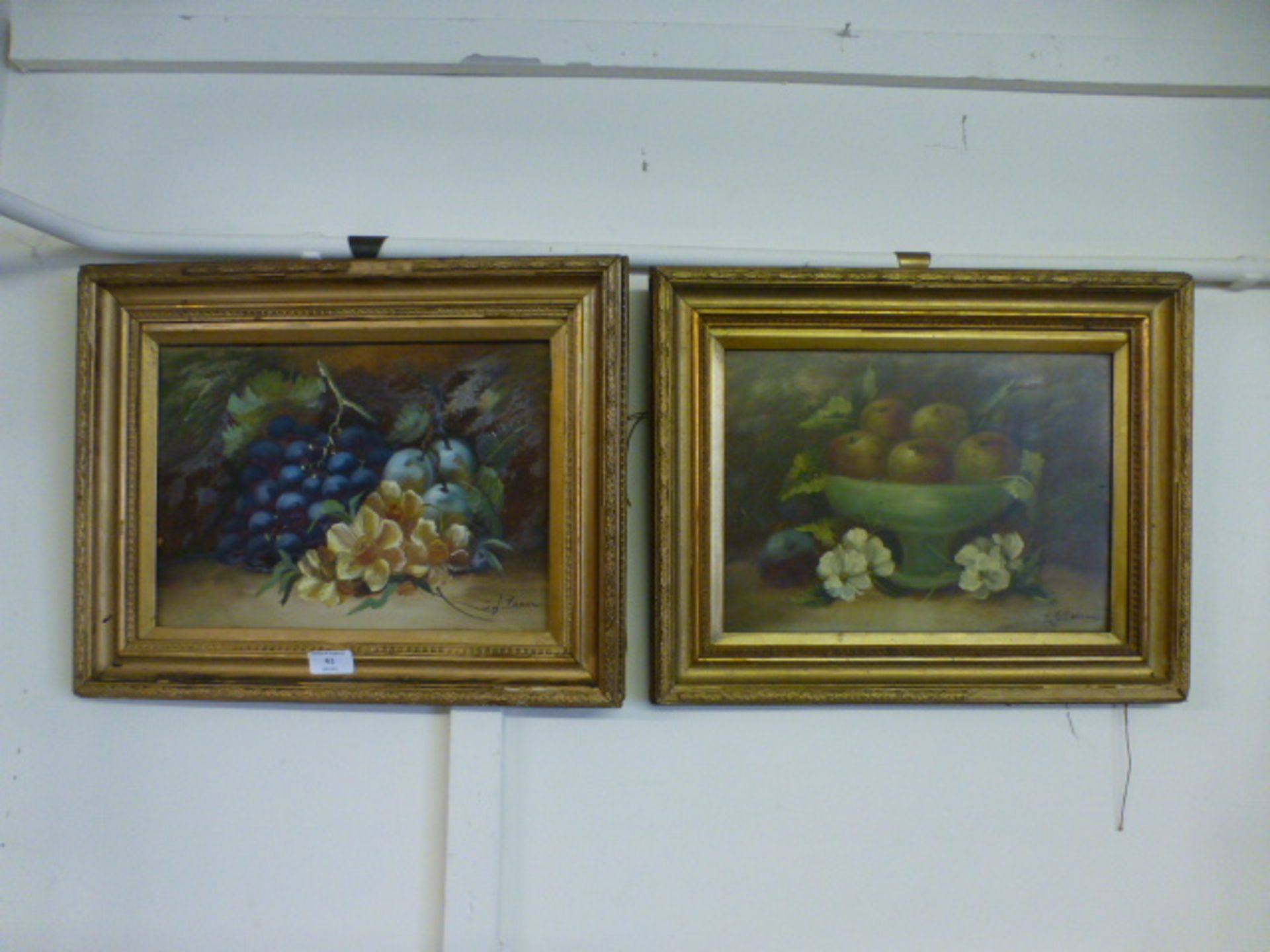 A pair of gilt framed oil on boards of still life signed bottom right