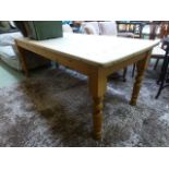 A stripped pine rectangular dinning table