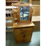 A modern pine three drawer bedside chest together with a pine magazine rack and a small modern pine