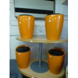A set of four orange and black leather effect pad seated stools