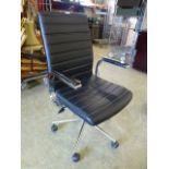 A black leather effect office chair on five star base