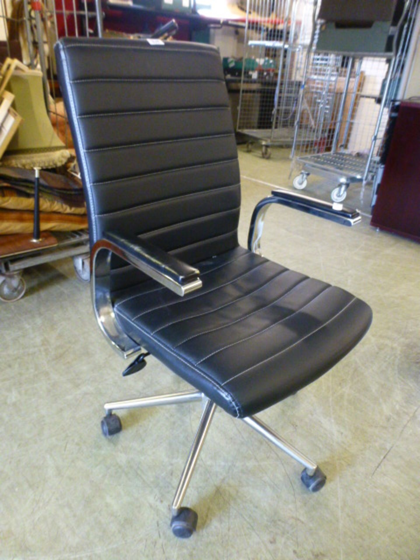 A black leather effect office chair on five star base