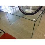A curved glass table/desk