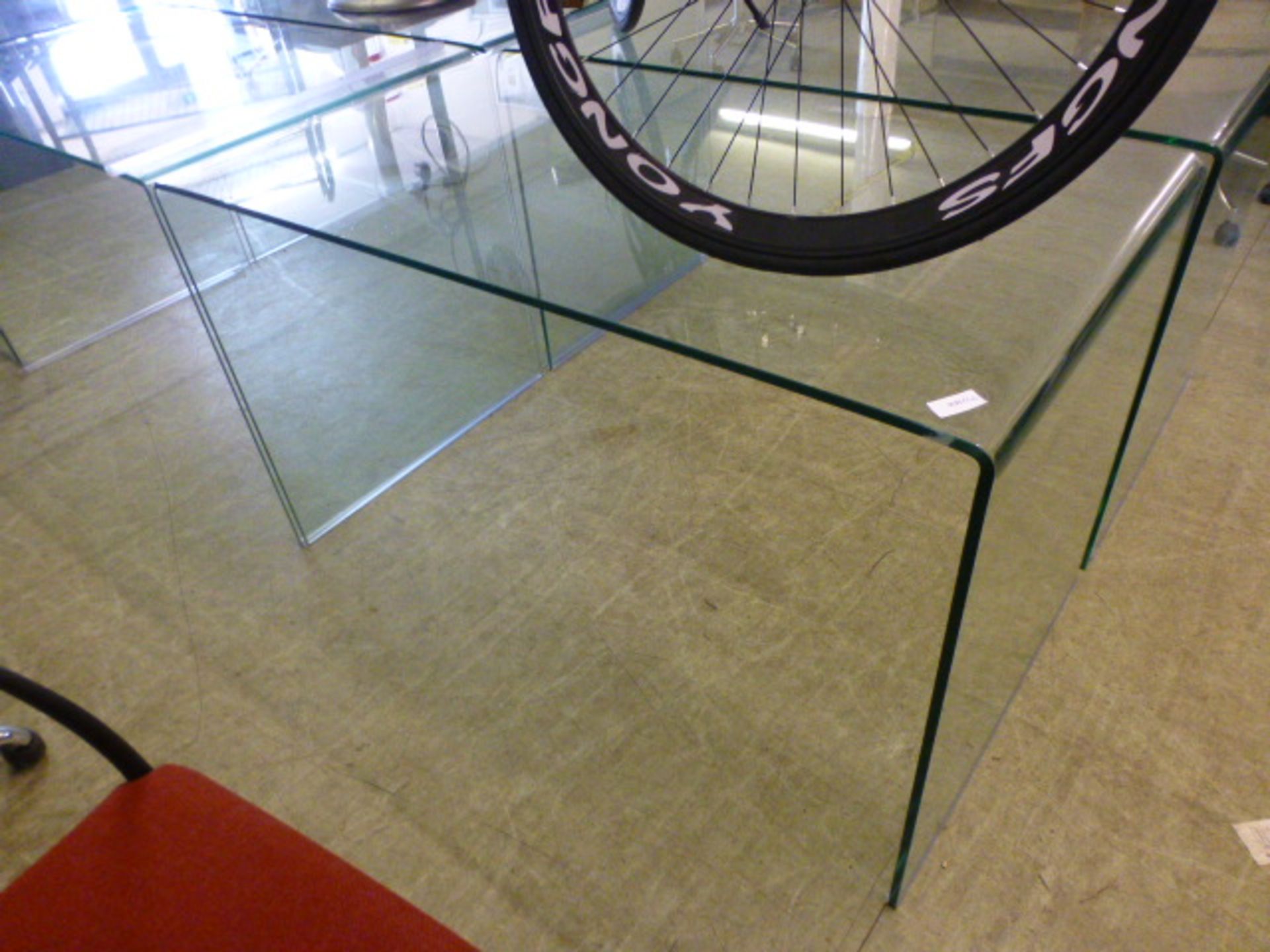 A curved glass table/desk