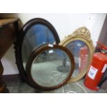 Three assorted early 20th century mirrors to include an oval oak framed mirror,