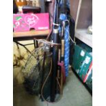 A selection of fishing equipment including rods and nets etc.